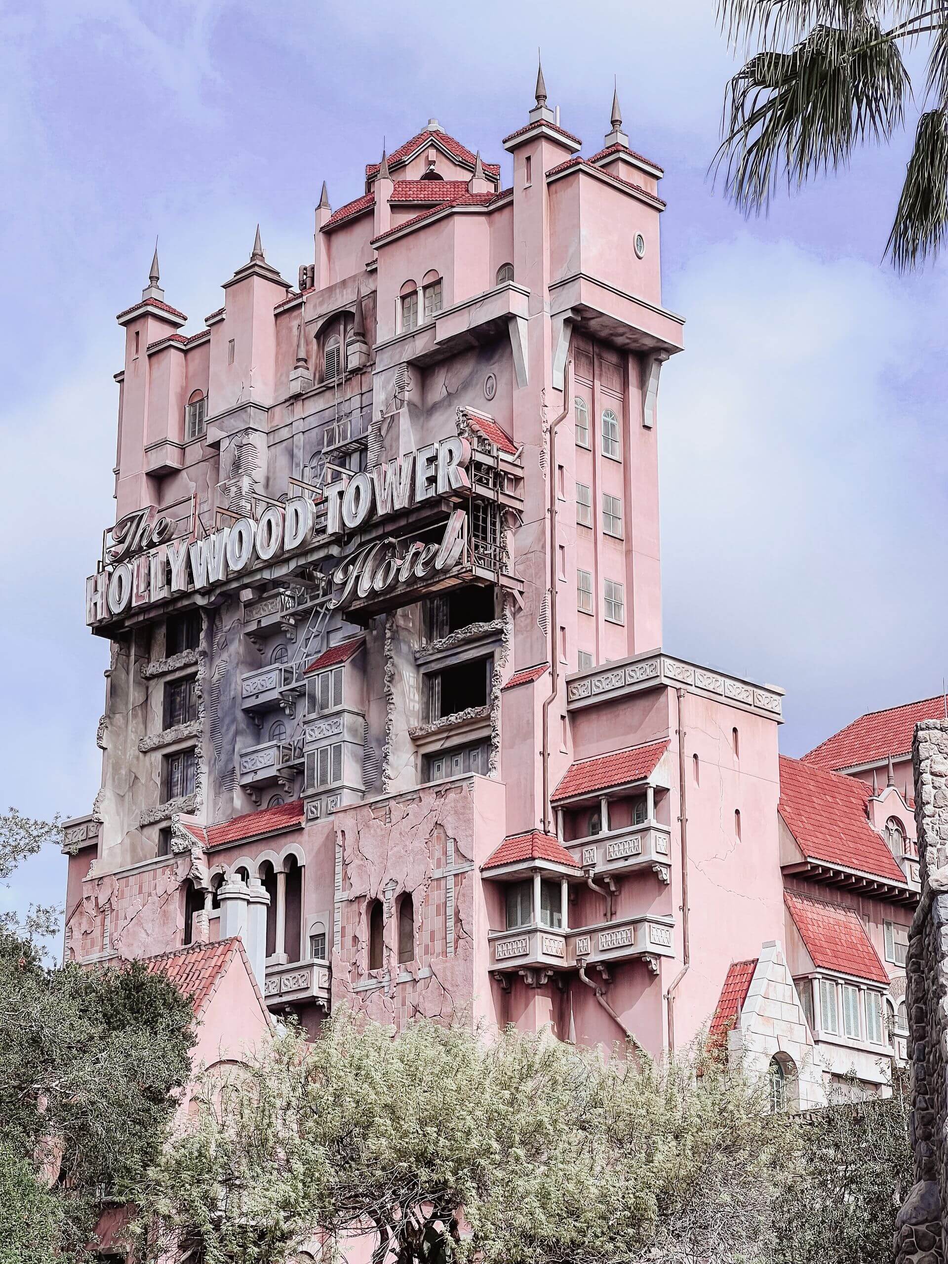 Iconic Hollywood Tower Hotel facade at an Orlando theme park with vintage architecture.