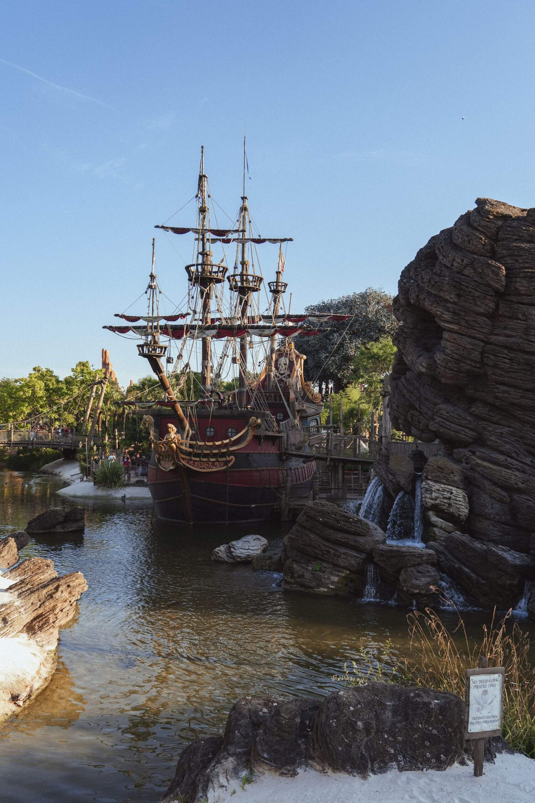 A stunning pirate ship at Disneyland Paris surrounded by natural beauty and themed landscapes.