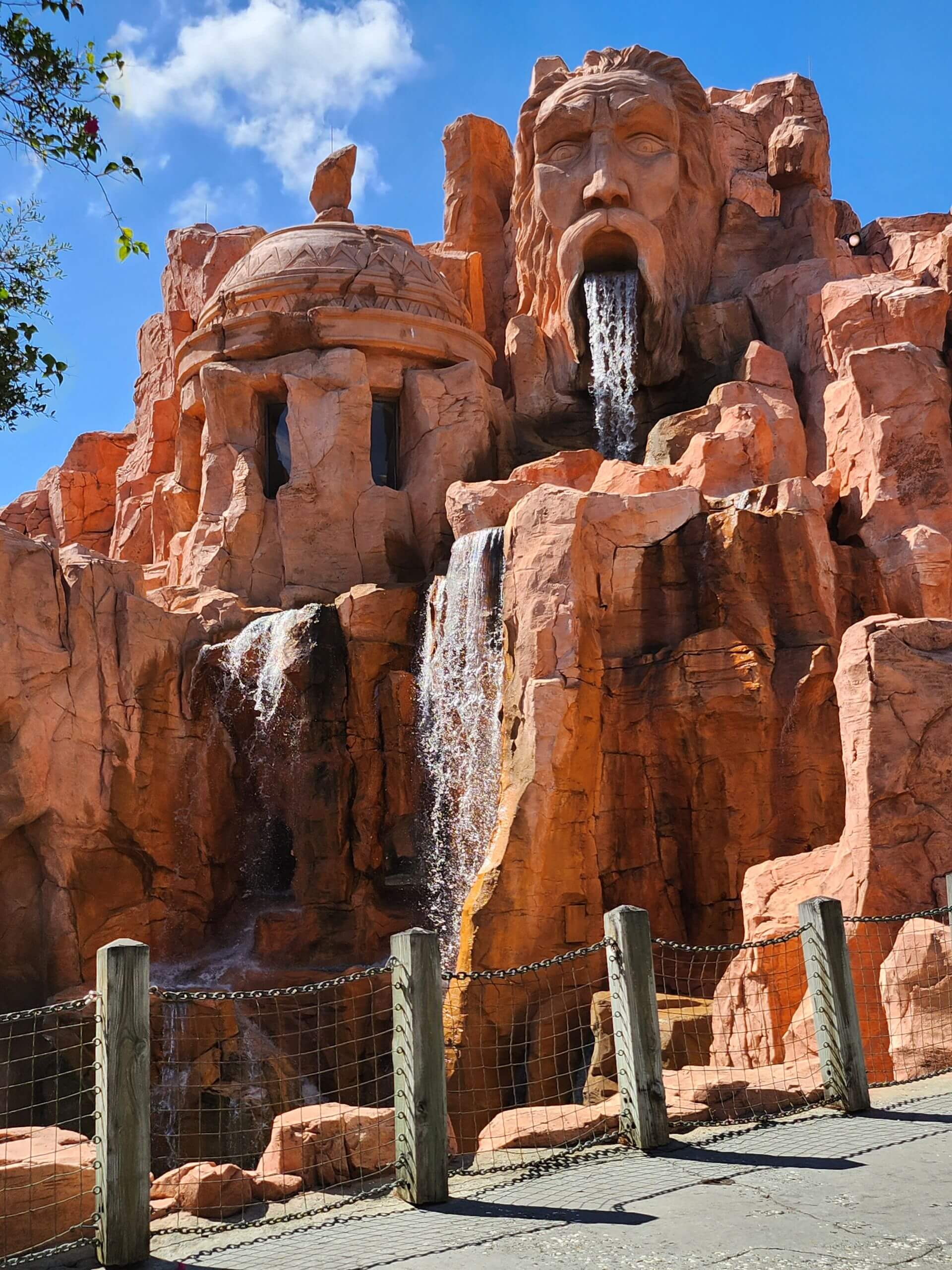 Stunning outdoor waterfall sculpture at Poseidon's Fury in Orlando's theme park.