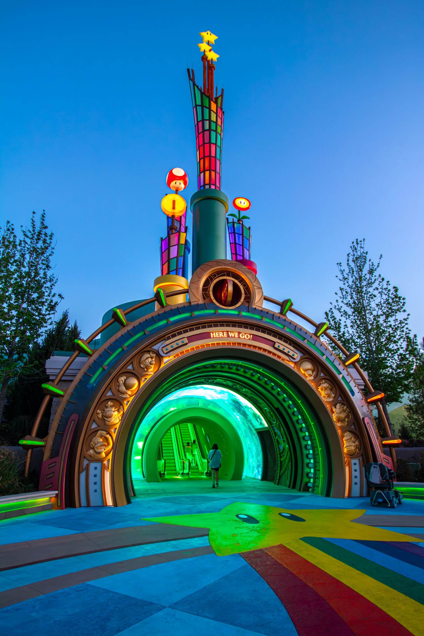 Vibrant evening view of colorful portal at Universal Orlando theme park entrance.